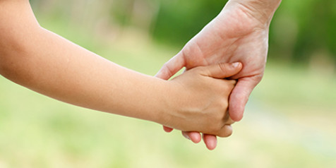Mother holds the hand of her child Mother holds the hand of her child